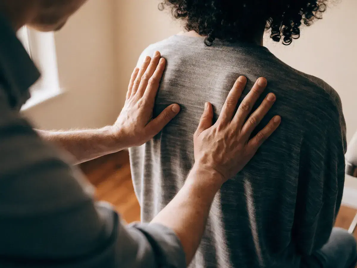 A doctor working with a patient during a rehabilitation session