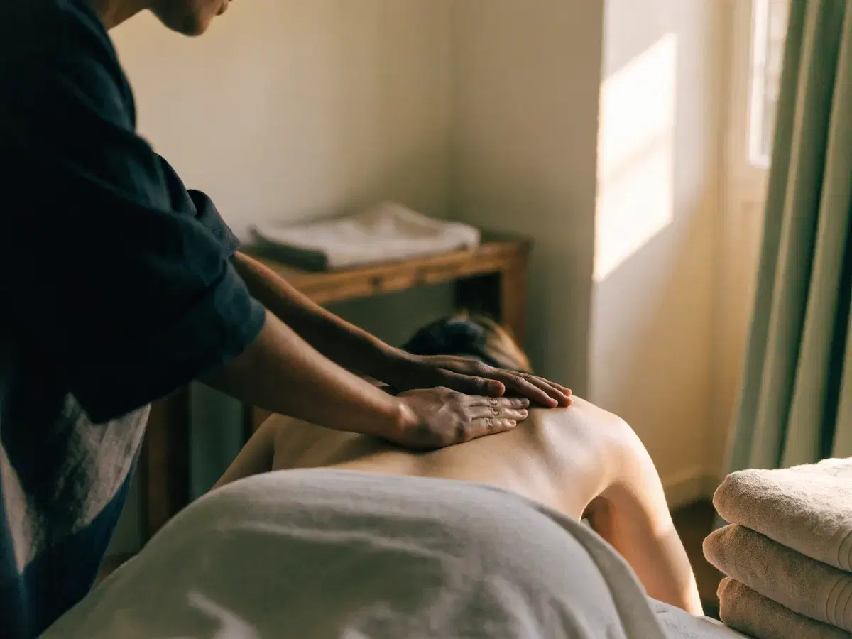 A massage therapist working on a client during a treatment session