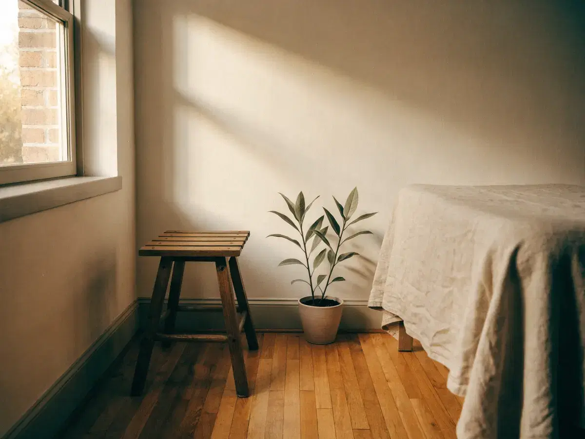 A quiet treatment room at the start of the day, morning light across the wall